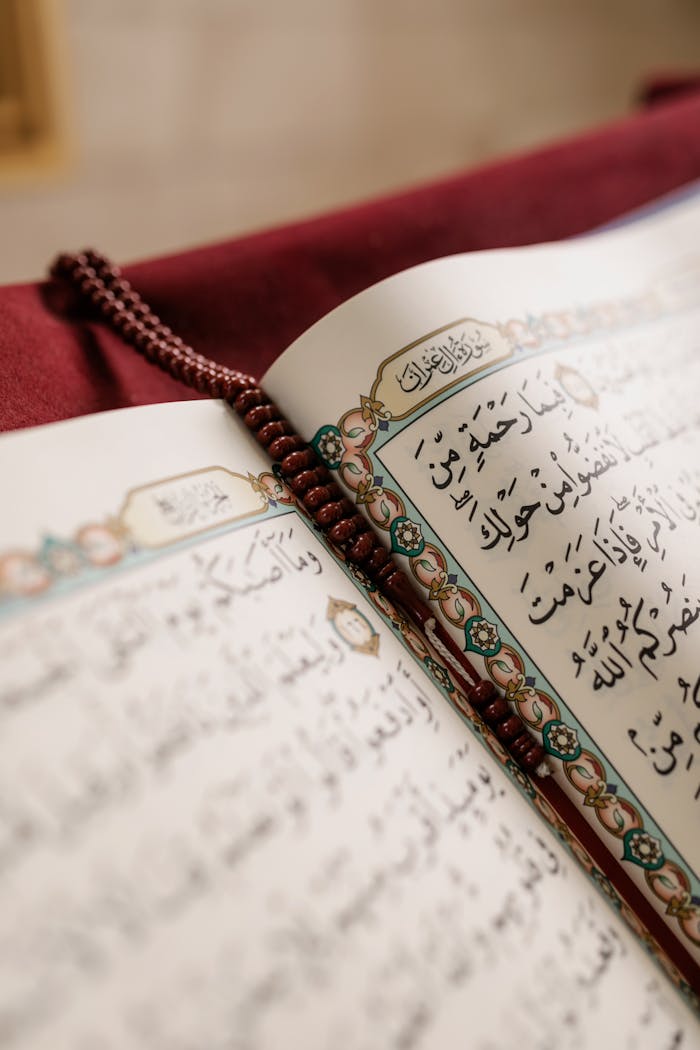 Detailed image of an open Quran with prayer beads, symbolizing Muslim culture and spirituality.